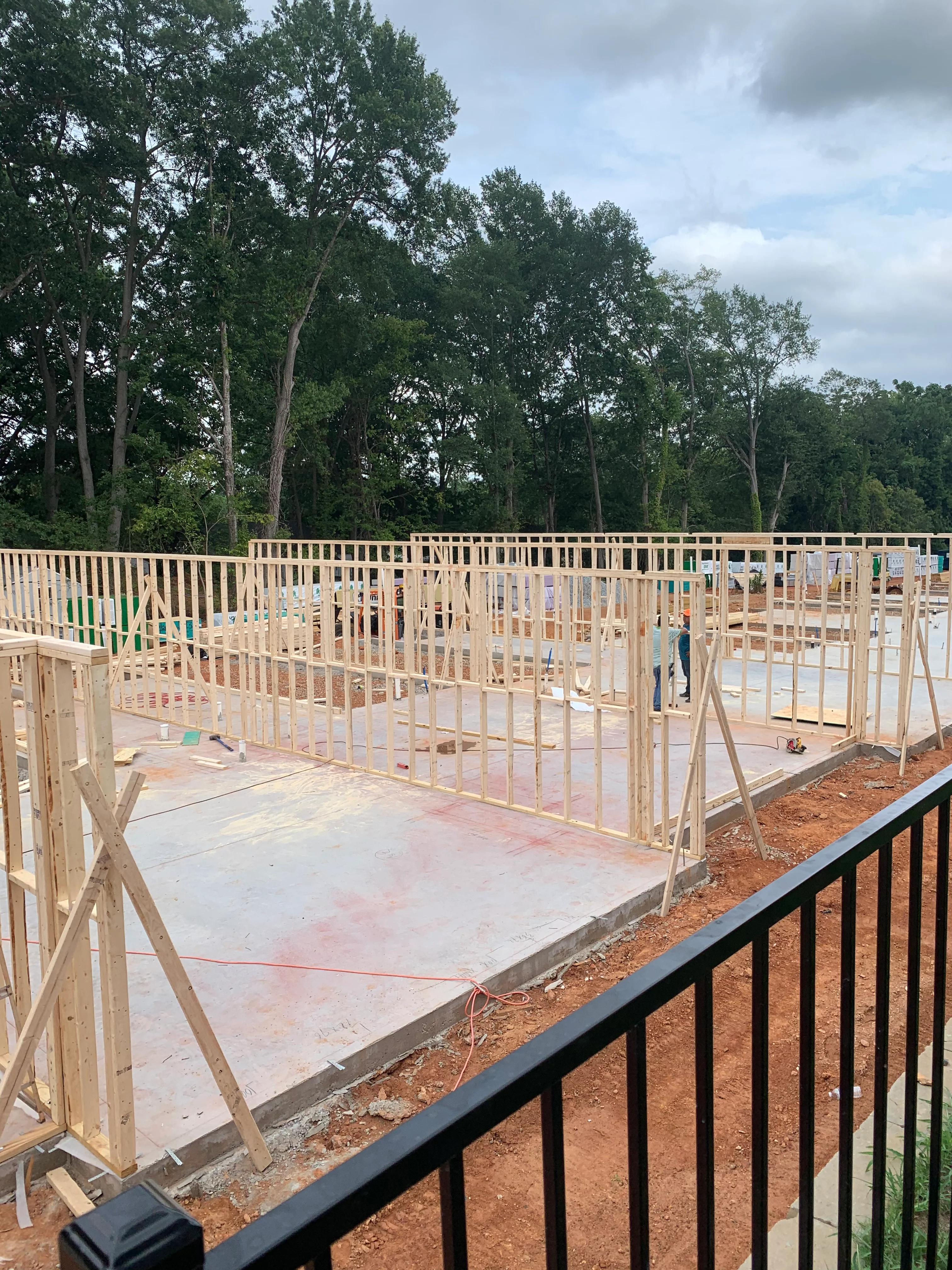 Wood-framed residential construction with concrete foundation slab and structural bracing