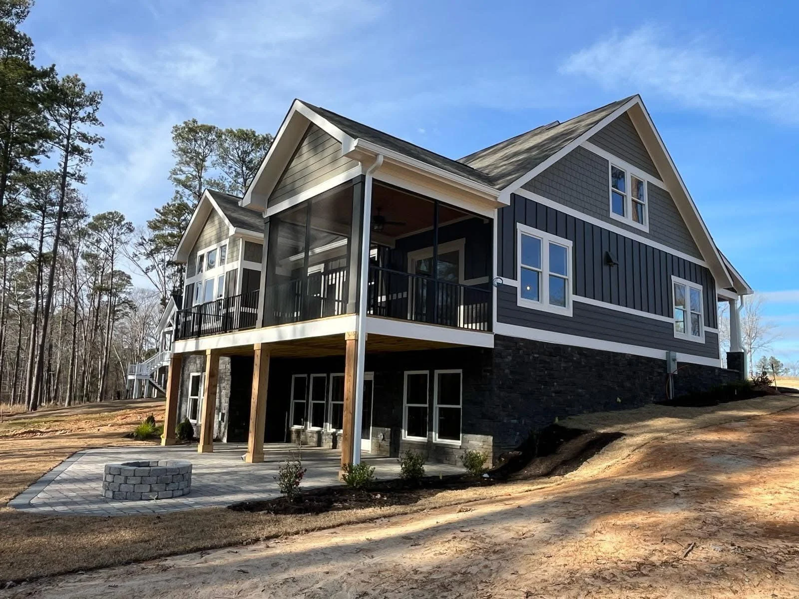 Dark asphalt shingle roof with white trim, multiple gables and dormers on elevated home