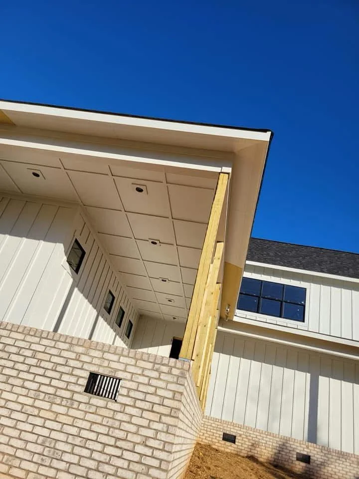 Cream aluminum soffit and fascia with recessed lights installed on commercial building exterior